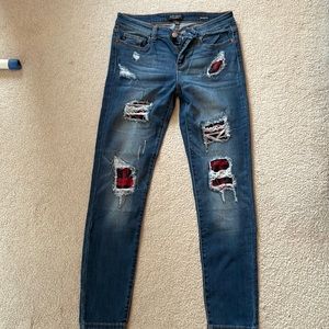 NWOT Judy Blue size 11 / 30 stretch distressed skinny jeans with Buffalo plaid.